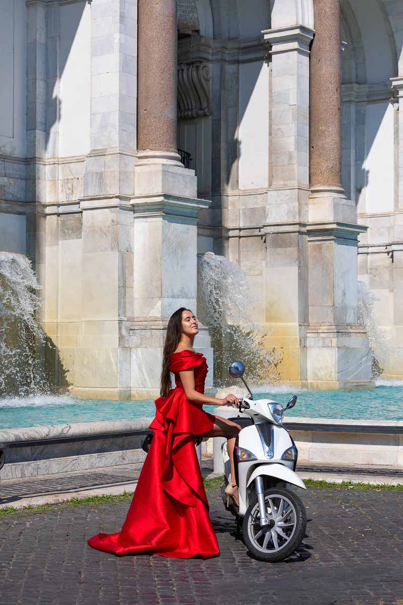 Bright red dress used during a roman photo shoot by the Janiculum hill water fountain 