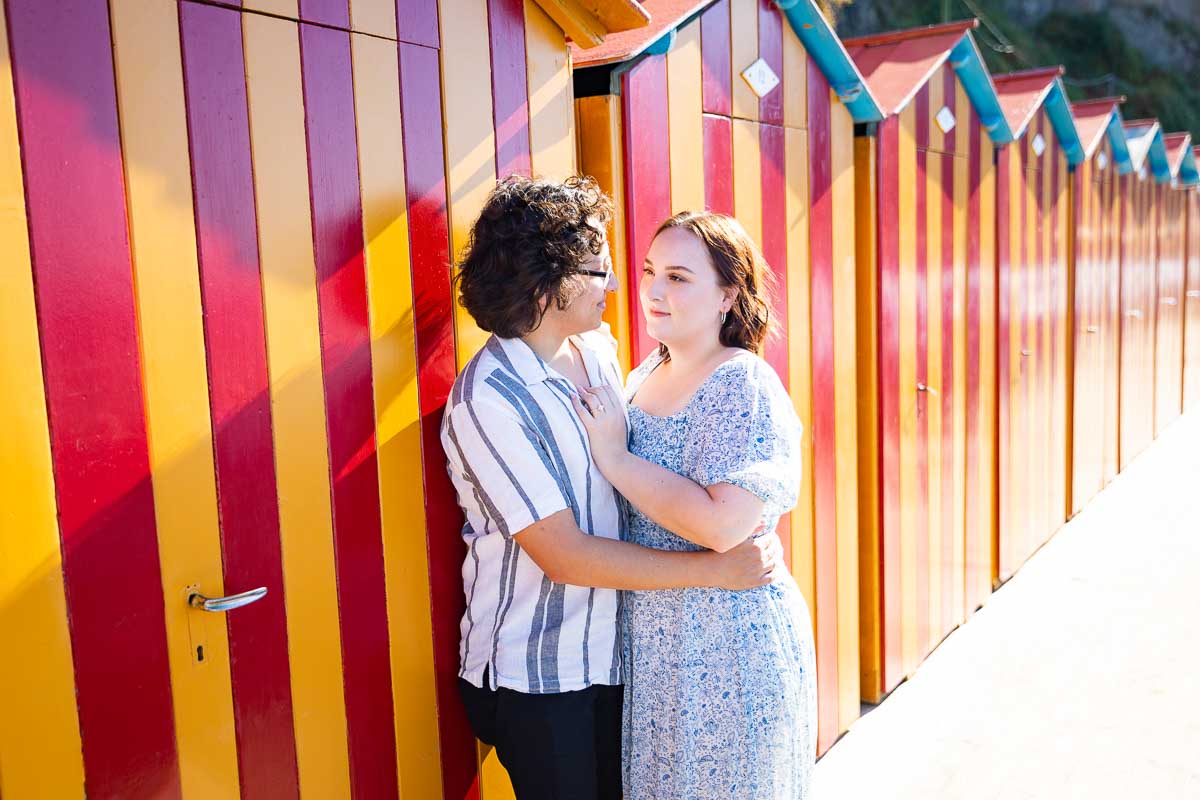 Picture portrait snapped by colorful cabins at the beach. Sorrento wedding proposal photography at a beach resort