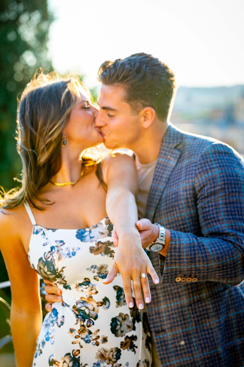 Couple closeup holding the engagement ring after a getting engaged