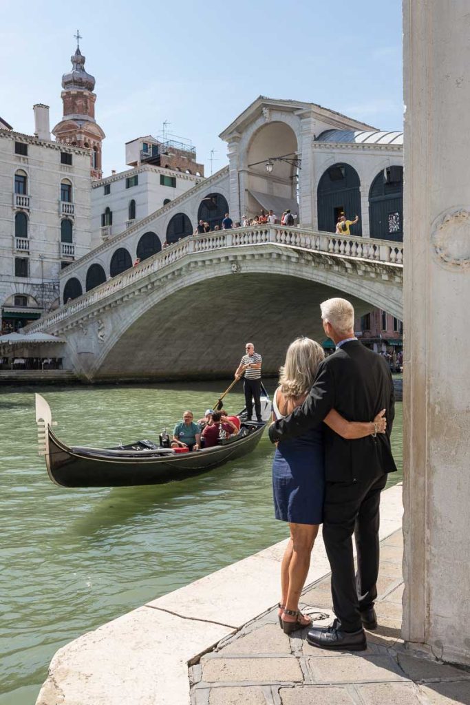 Looking at the Rialto bridge as gondola slowly float by on Canal grande