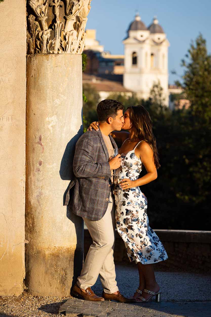 A romantic moment photographed during a photoshoot in Italy. Kissing while leaning into an ancient roman column
