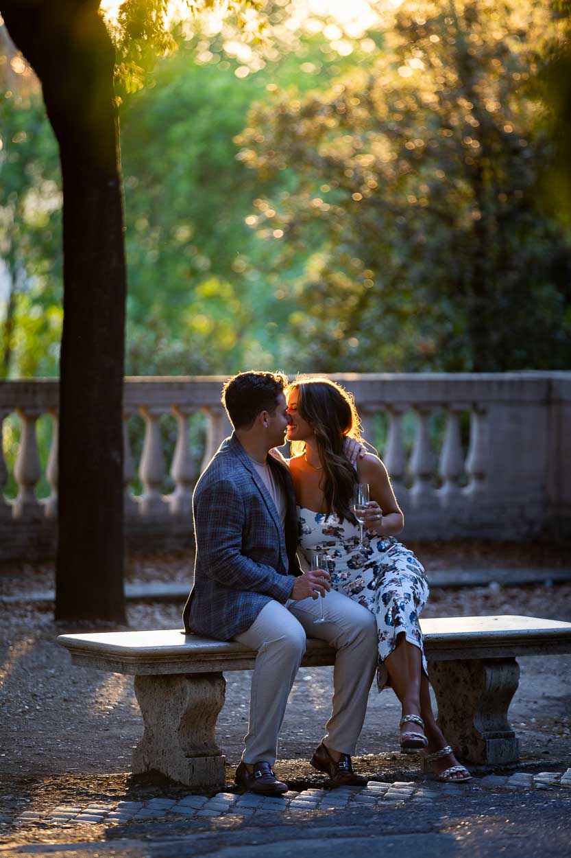 Celebrating engagement with a prosecco toast during a photography session at sunset