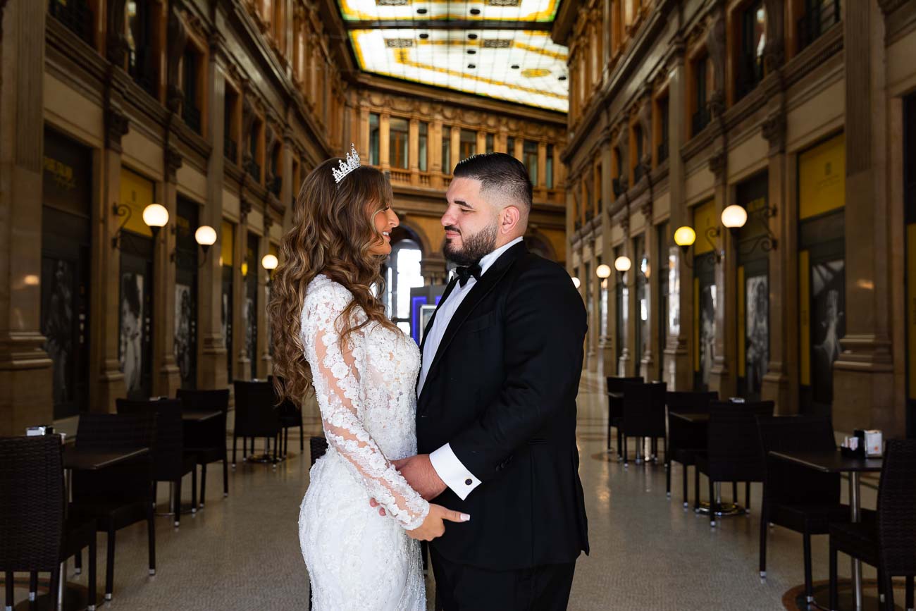 Bride with Groom standing together facing each other while taking their wedding pictures in Italy