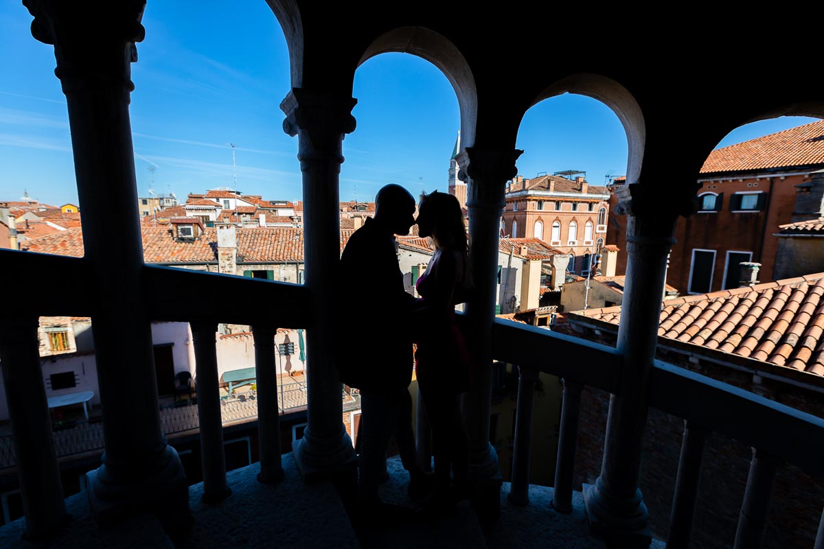 Silhouette image of a couple standing together inside the scalinata staircase