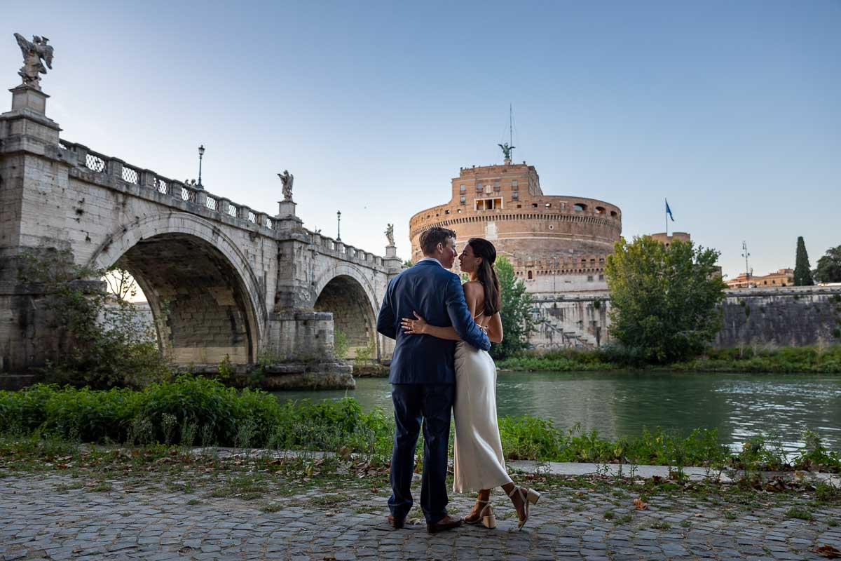 Couple portrait photographed at the Castel San Angelo bridge. During an engagement photo shoot