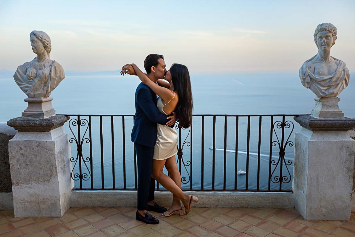 In Love photoshoot posed picture in between ancient marble statue and a unique view over the Mediterranean sea in Italy