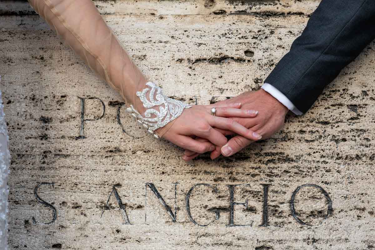 Picture matrimonial rings photographed over the ancient encryption of Ponte S. Angelo Italy