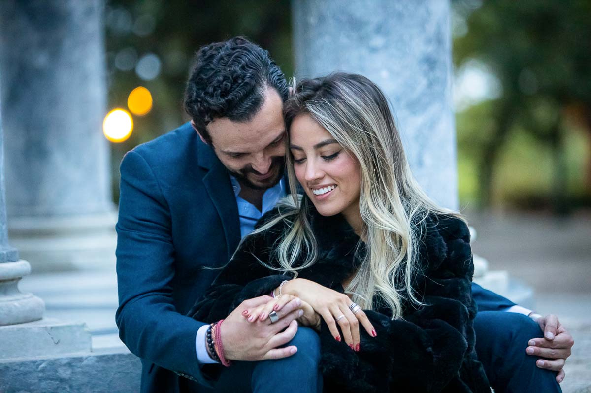 Admiring the engagement ring together during an evening couple photo shoot