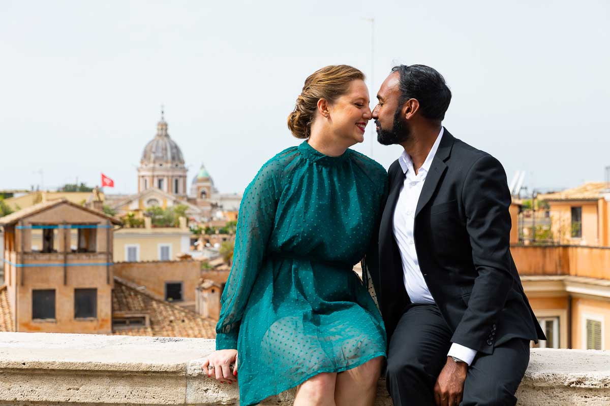 Kissing over the panoramic view of the Rome skyline
