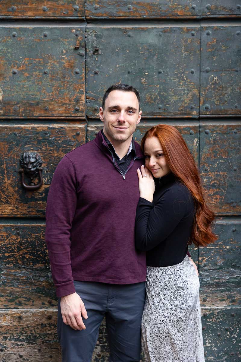 Couple portrait photographed in front of an ancient green doorway