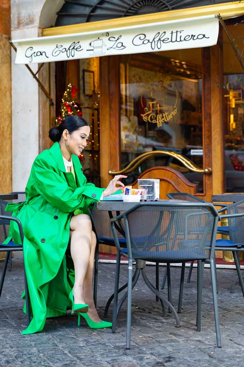 Bright colorful outfit change into gree. Editorial photo session at a caffe in Rome Italy
