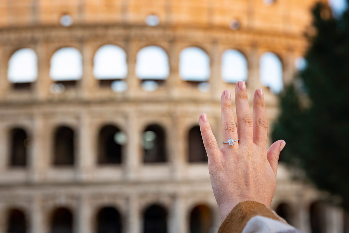 Engagement ring picture taken in front of Coliseum used as backdrop