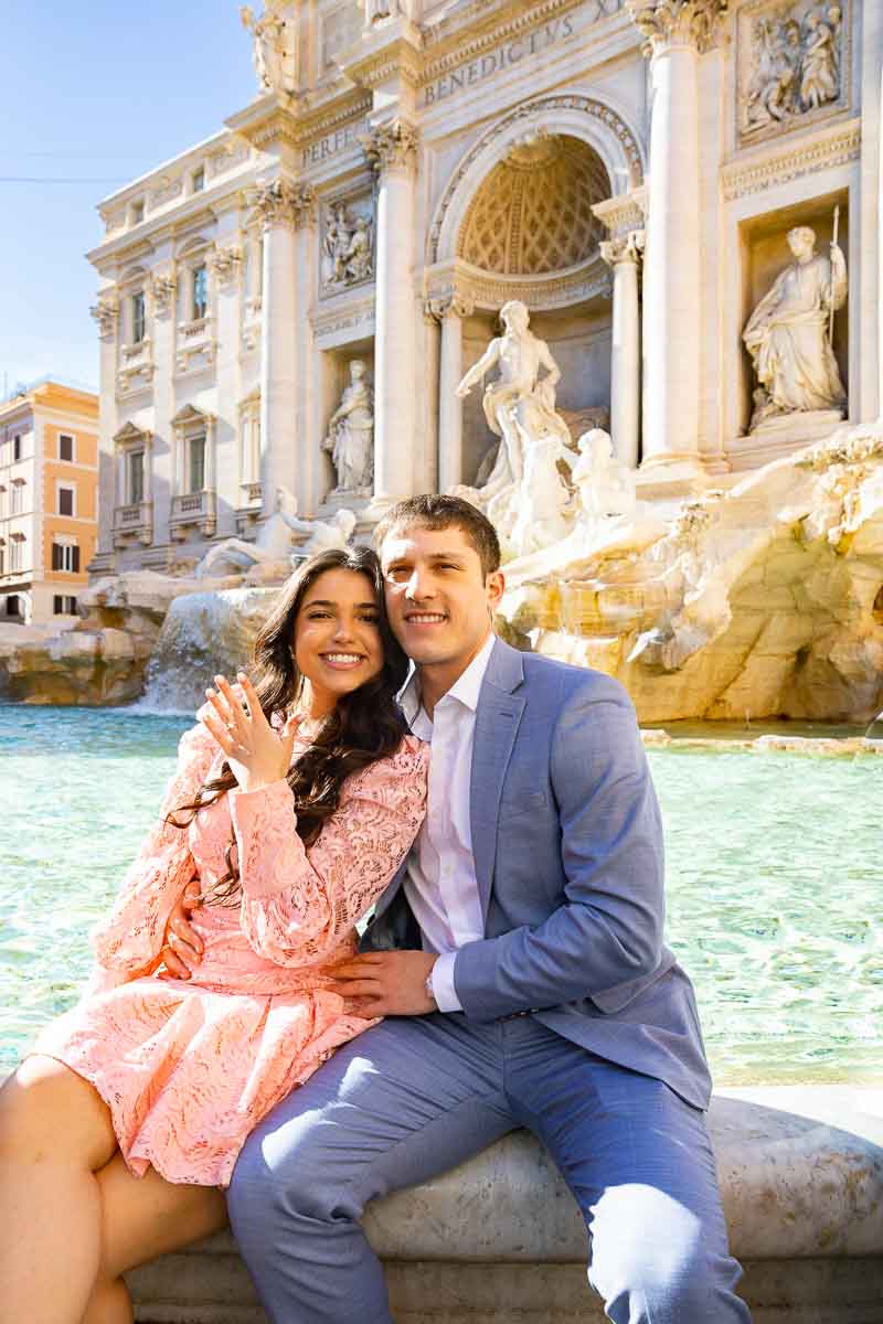 Sitting edge Trevi fountain showing off the new engagement ring