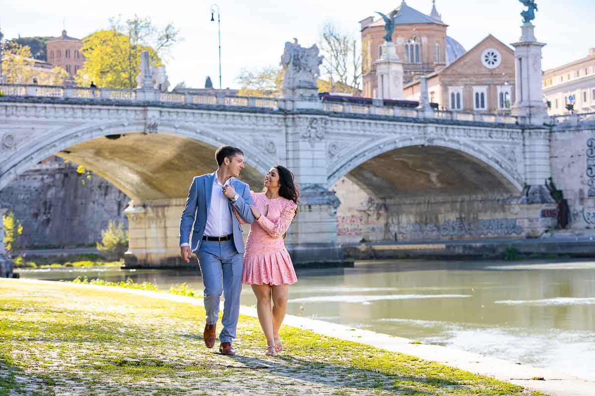 Walking together while taking picture by the Tiber river