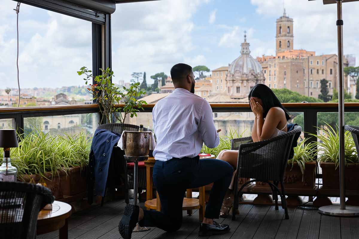 03-knee-down-proposal Man knee down wedding marriage proposal overlooking the city of Rome from afar on a terrace with a view