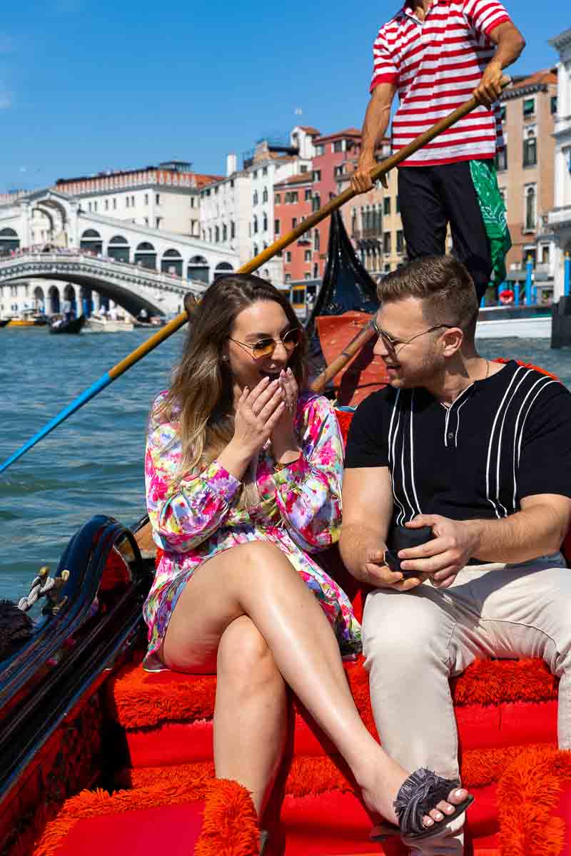 Surprise wedding promise candidly photographed on a gondola ride by a professional photographer