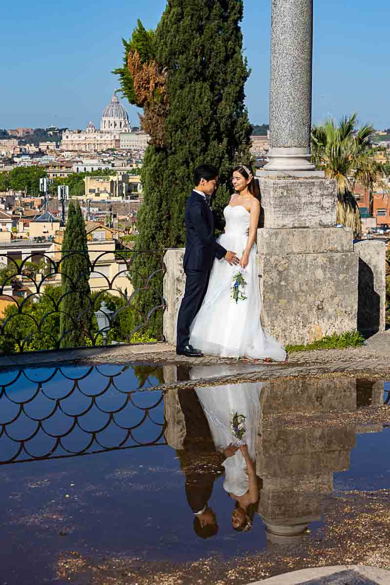 The water reflection groom and bride posed during a photo session Pincio park terrace outlook