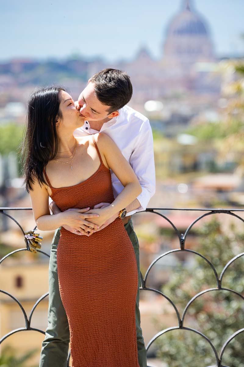 Close up kissing portrait in front roman skyline