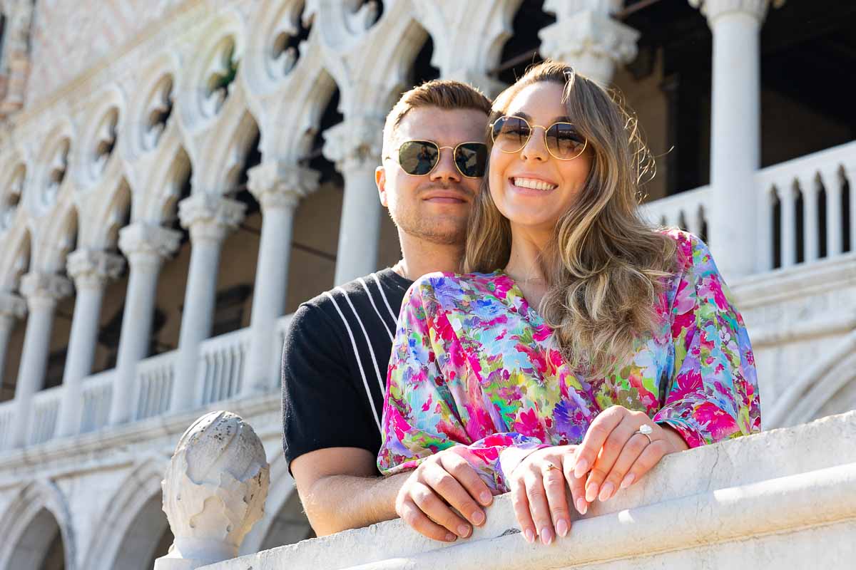 Couple smiling portrait taken in front of Palazzo Ducale during a photoshoot with professional photographers