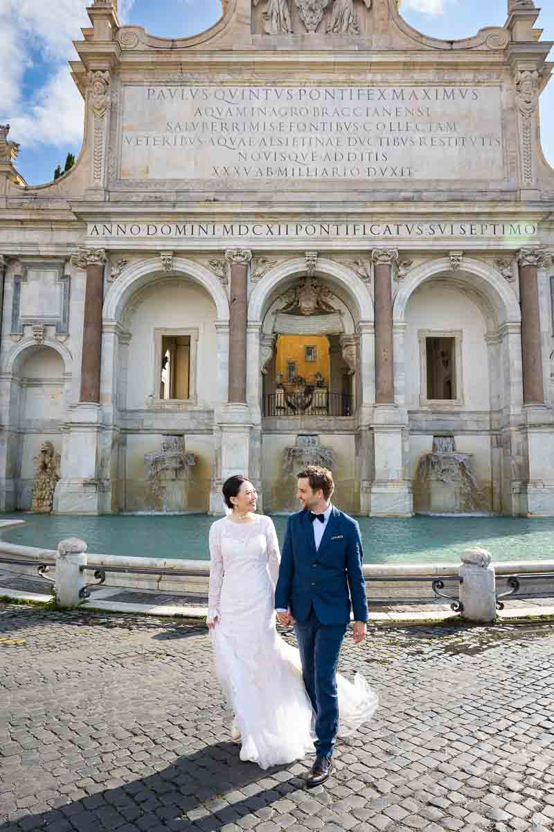 Walking across the street from the Fountain of Acqua Paola also known as Fontanone during a roman photoshoot session eternal city