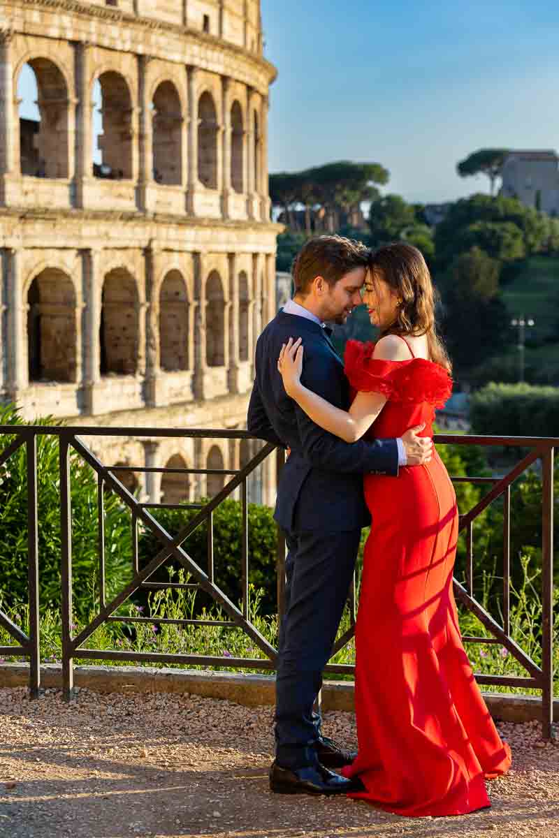 Couple taking formal pictures Colosseum Italy during the golden hour