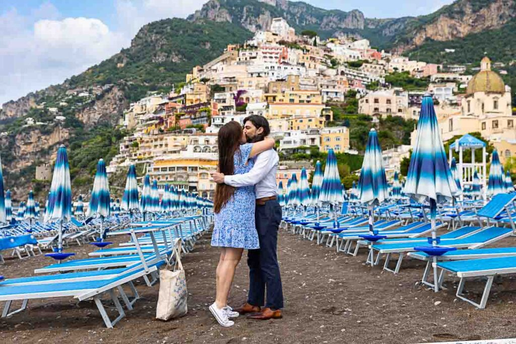 Proposing marriage among typical beach umbrellas found on the beachfront