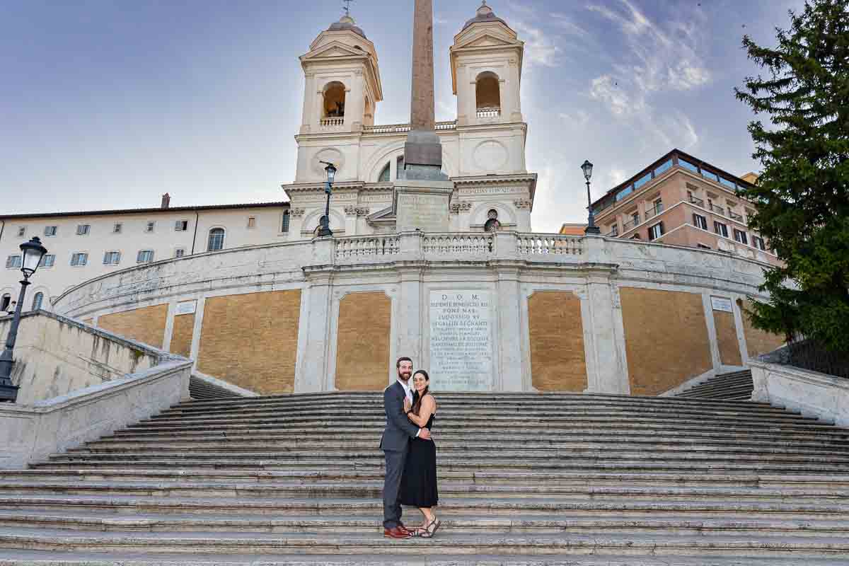 Standing steps of the Spanish steps with church Trinita' dei Monti background 