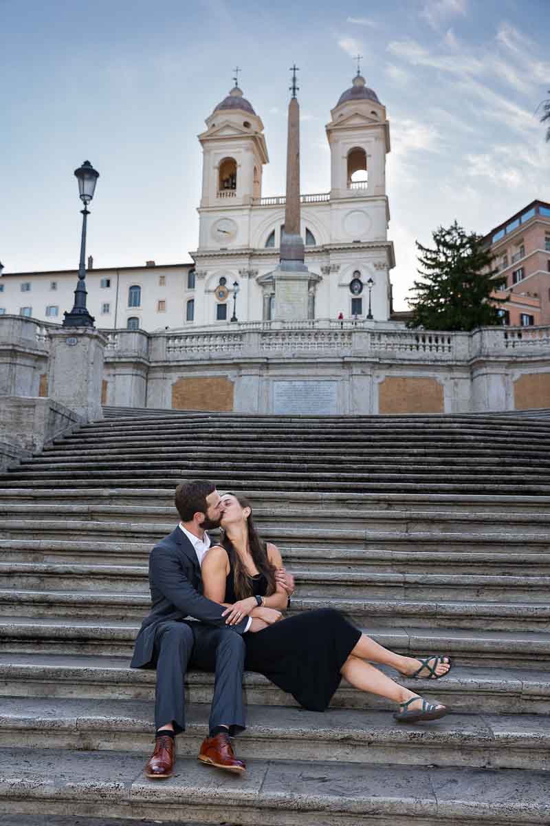 Couple sitting down Spanish steps during a photo shoot 
