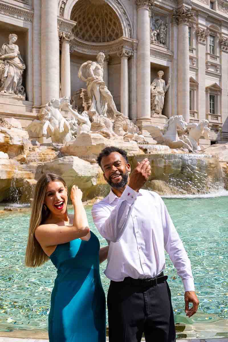 Throwing in the coin into the Trevi water fountain in the hope of coming back again in Italy to visit