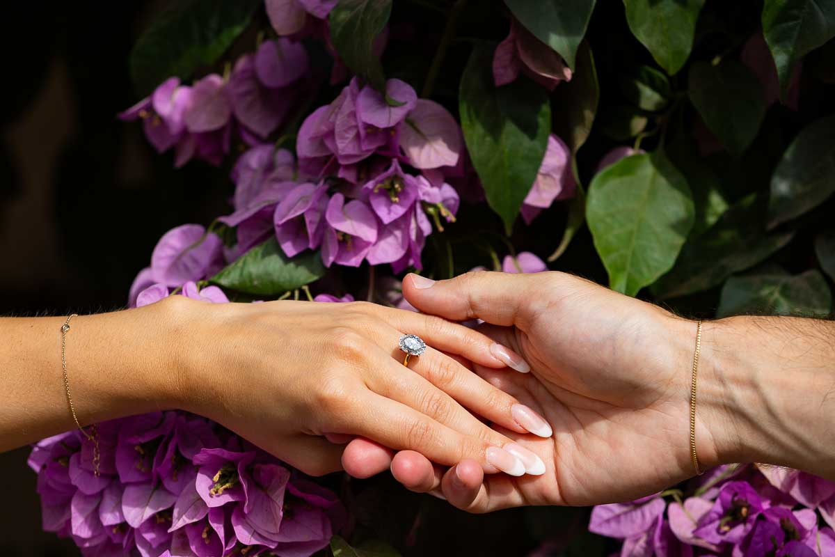 Picture of the Engagement ring photographed up close in front of bouganville fuchsia flowers