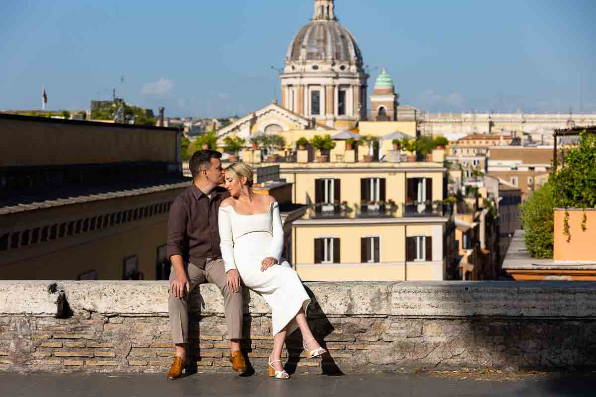 Sitting down on a small wall taking portrait pictures in Italy