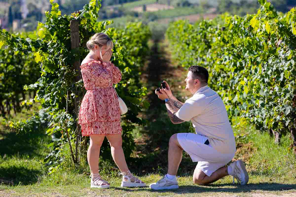 Proposal moment at the edge of vineyard rows in the Tuscan countryside