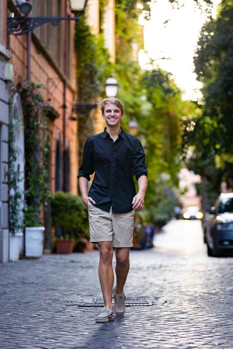 Walking solo shot senior pictures taken on a cobblestone alleyway