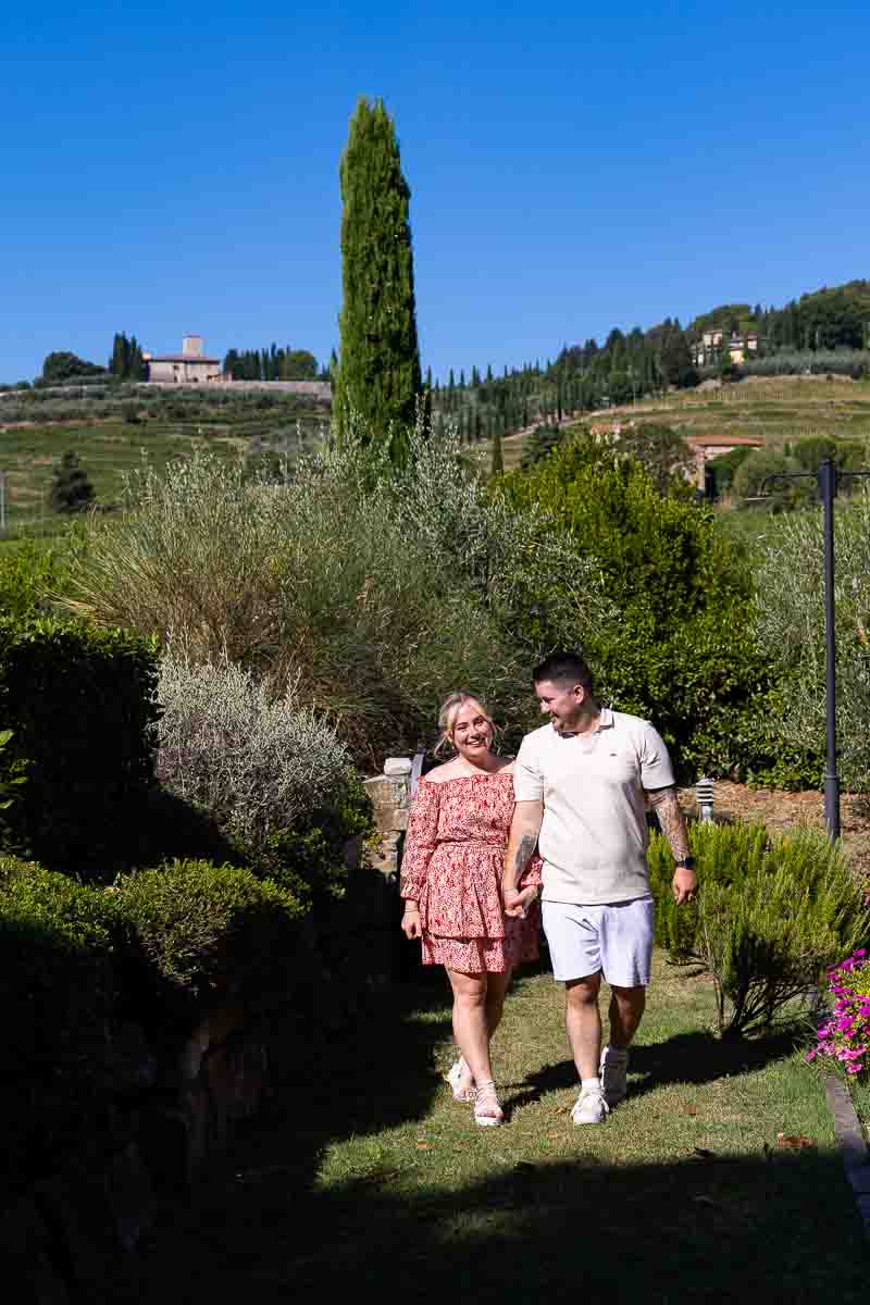 Walking together during a tuscan photo shoot in the countryside of a typical winery 