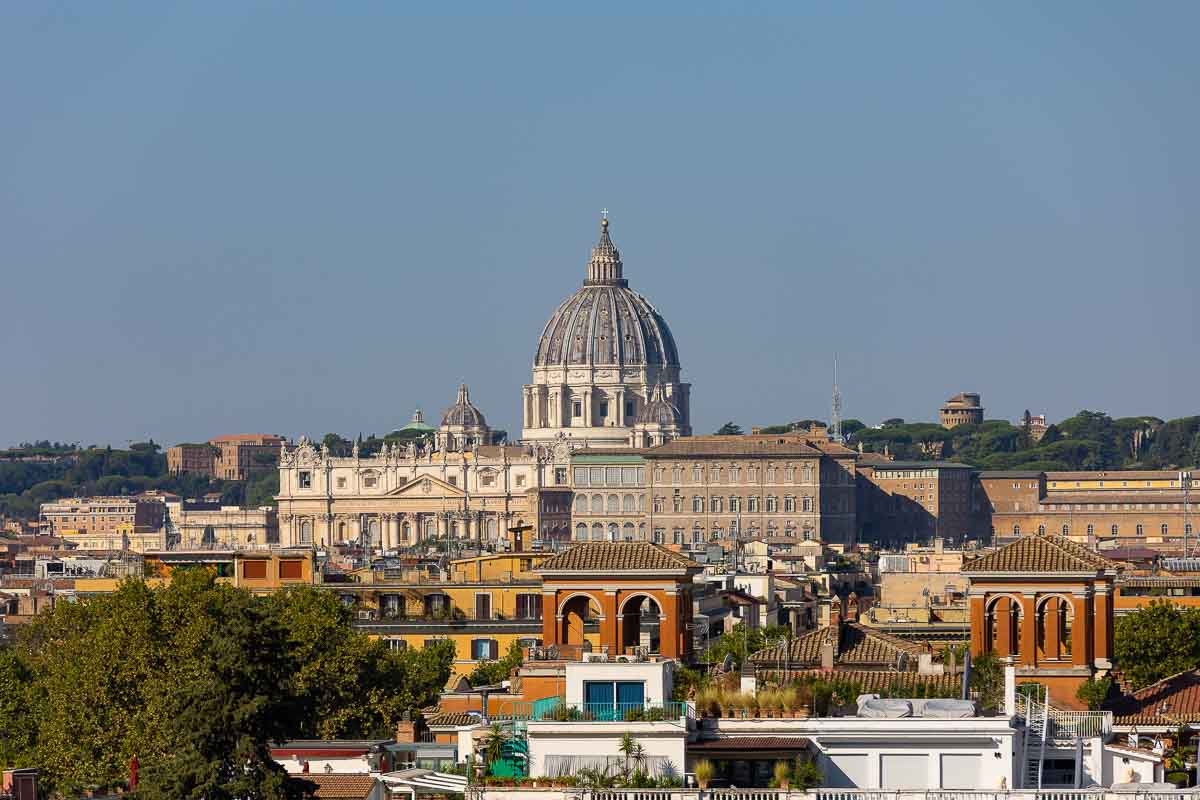Roman cityscape photographed with Saint Peter's cathedral dome far distance from the Vatican 