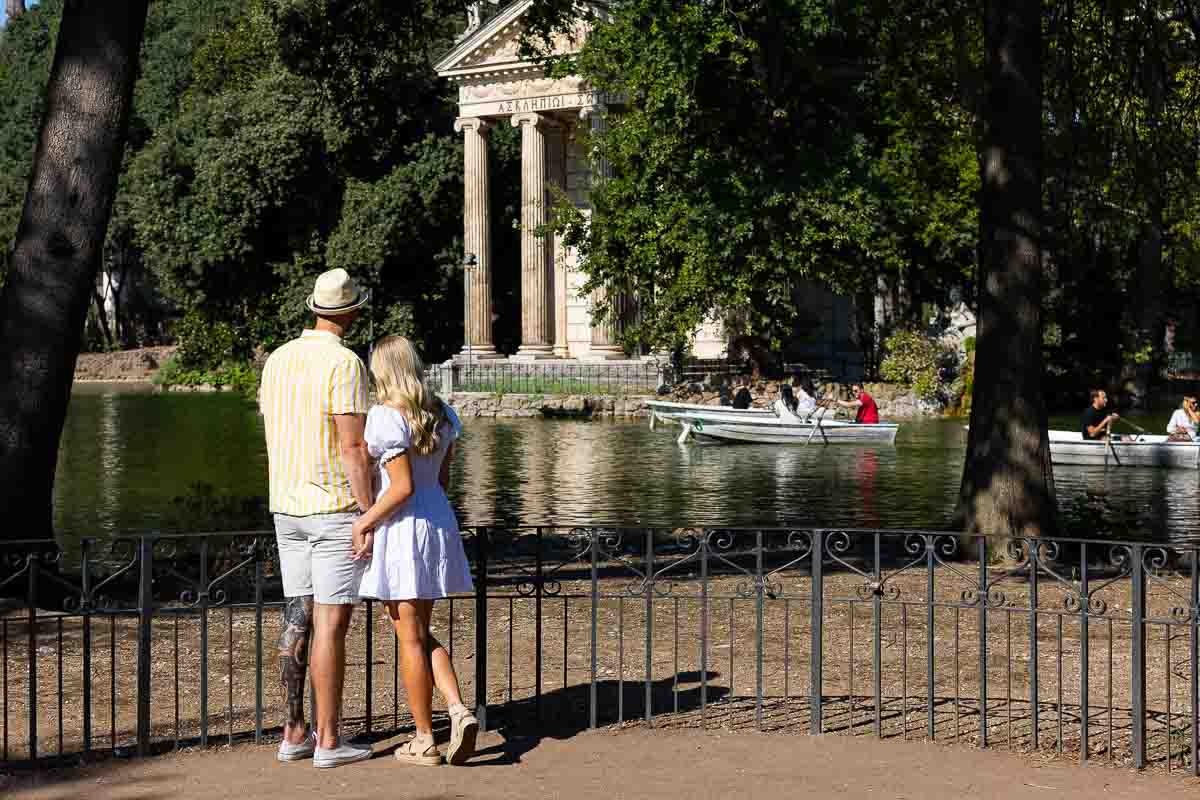Looking together Temple of Aesculapius foundat the lake Borghese garden