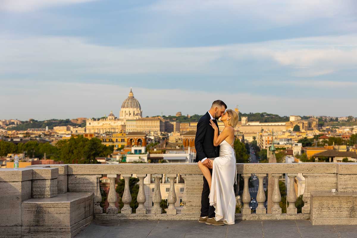 Beautiful morning picture of a just married couple posing in front skyline Pincio park terrace 