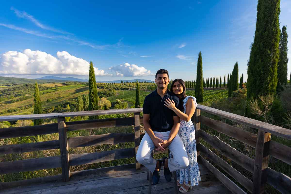 Posed portrait picture taken on a stool before the scenic view of the Tuscan countryside