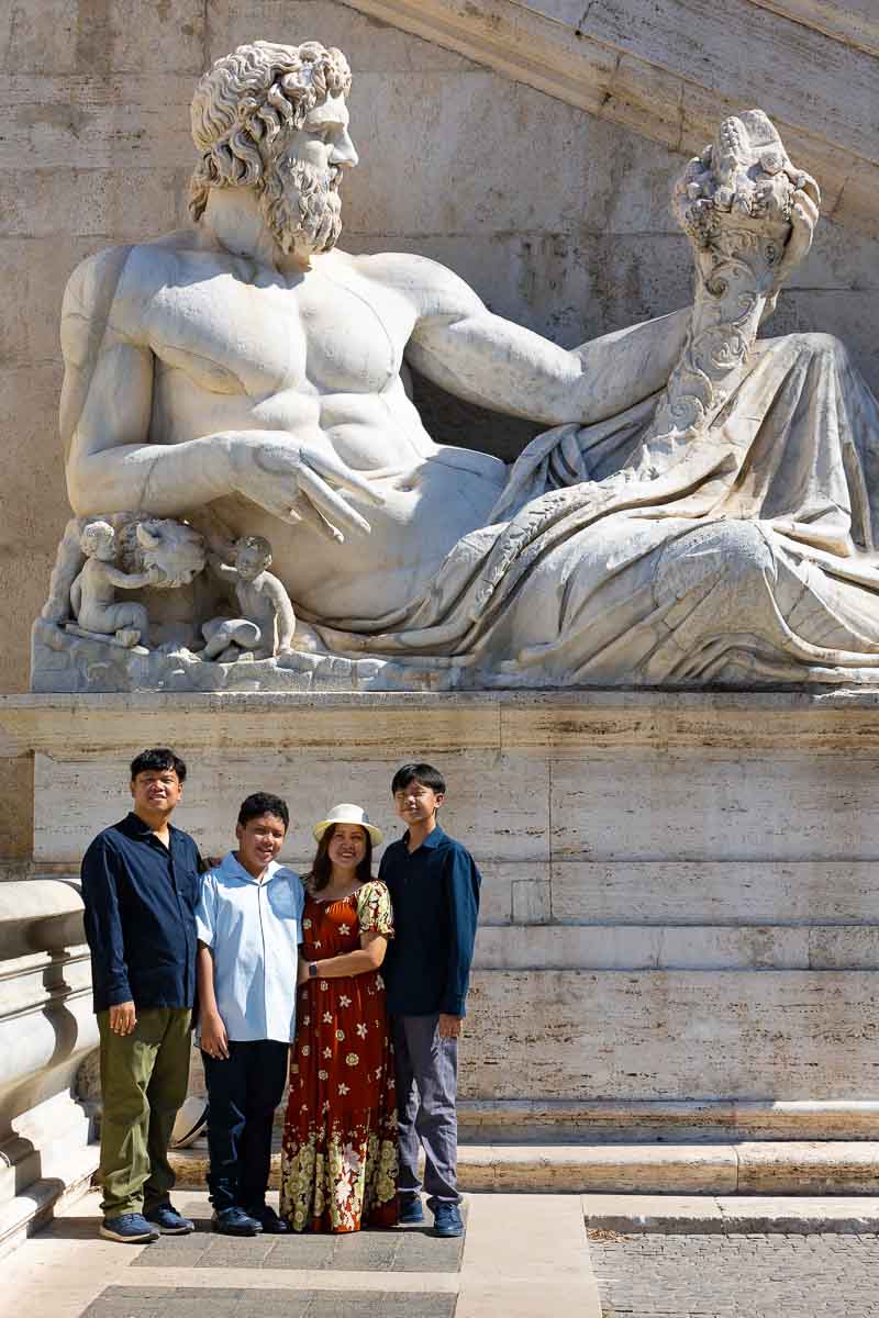 Posed picture underneath an ancient Roman Marble Statue. Family Vacation Photography