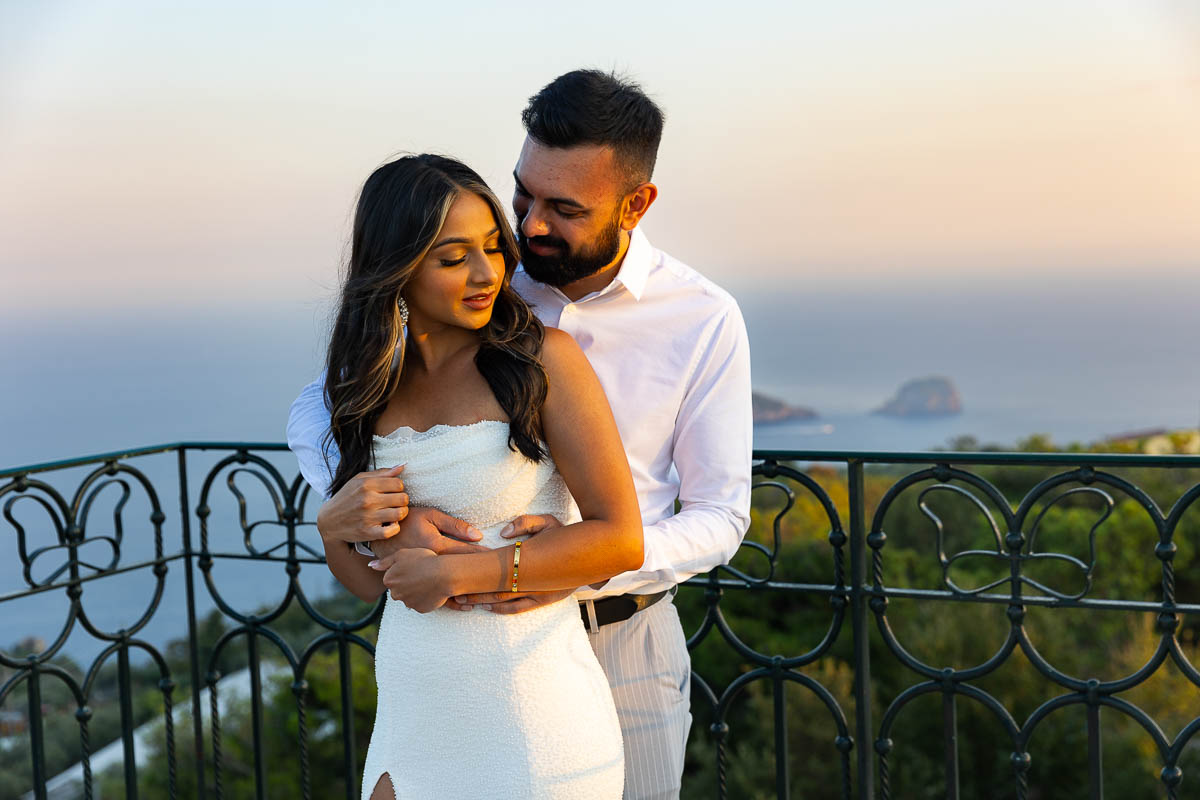 Couple portrait at sunset over the sea