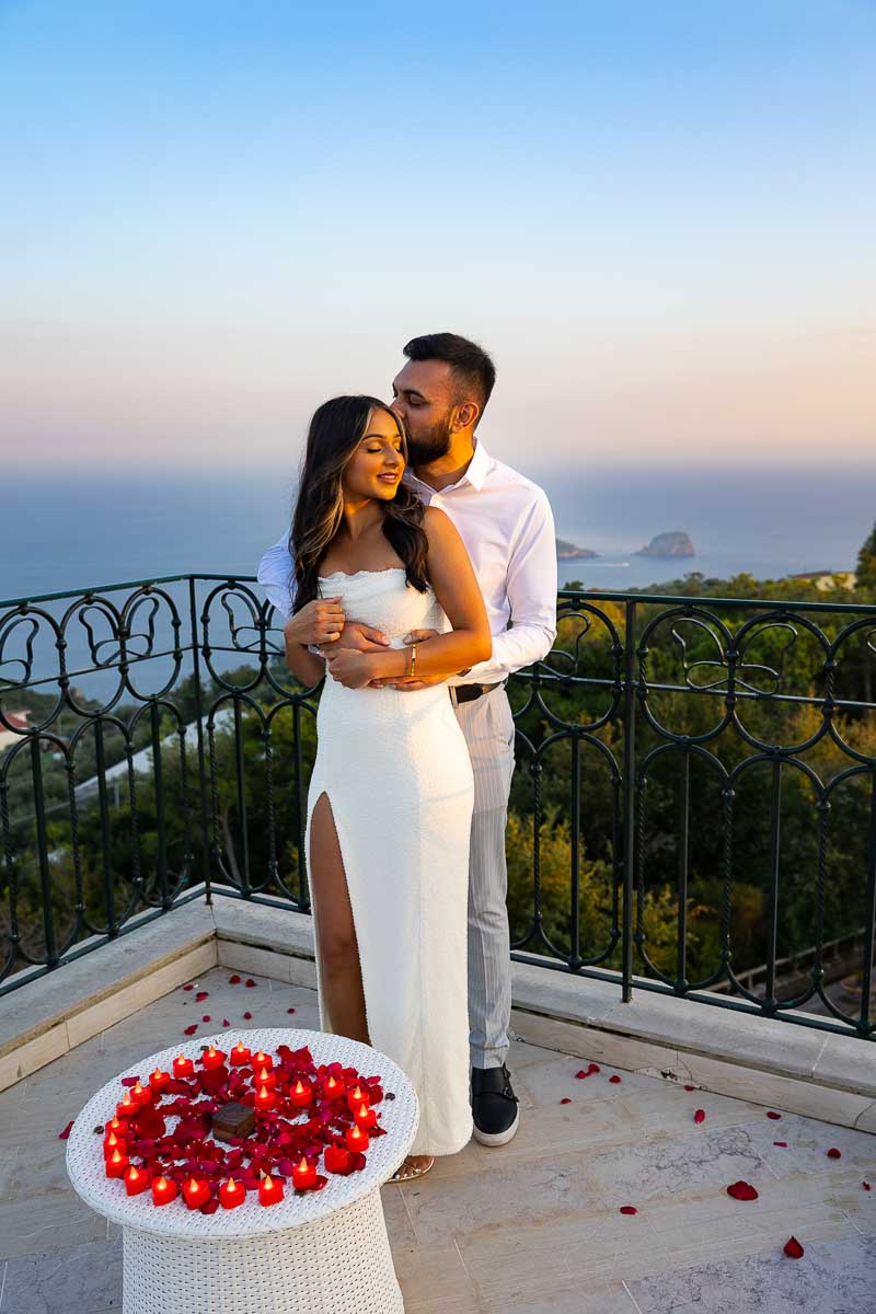 Couple standing on a terrace posed for engagement photography