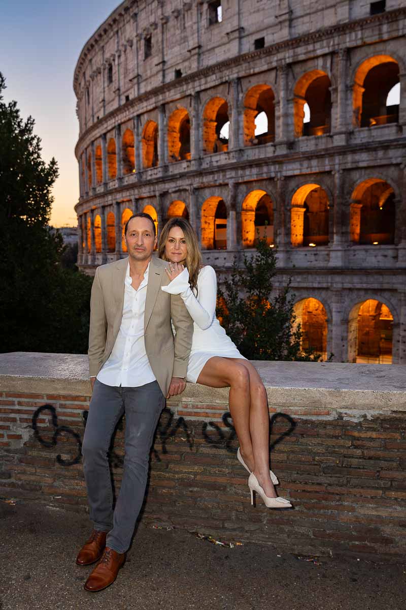 Sitting down in front Colosseum during a couple Rome photoshoot