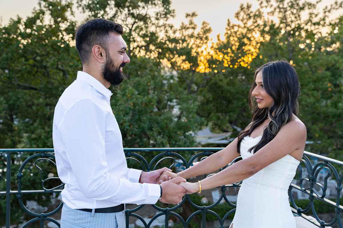 Holding hands on a terrace during golden hour