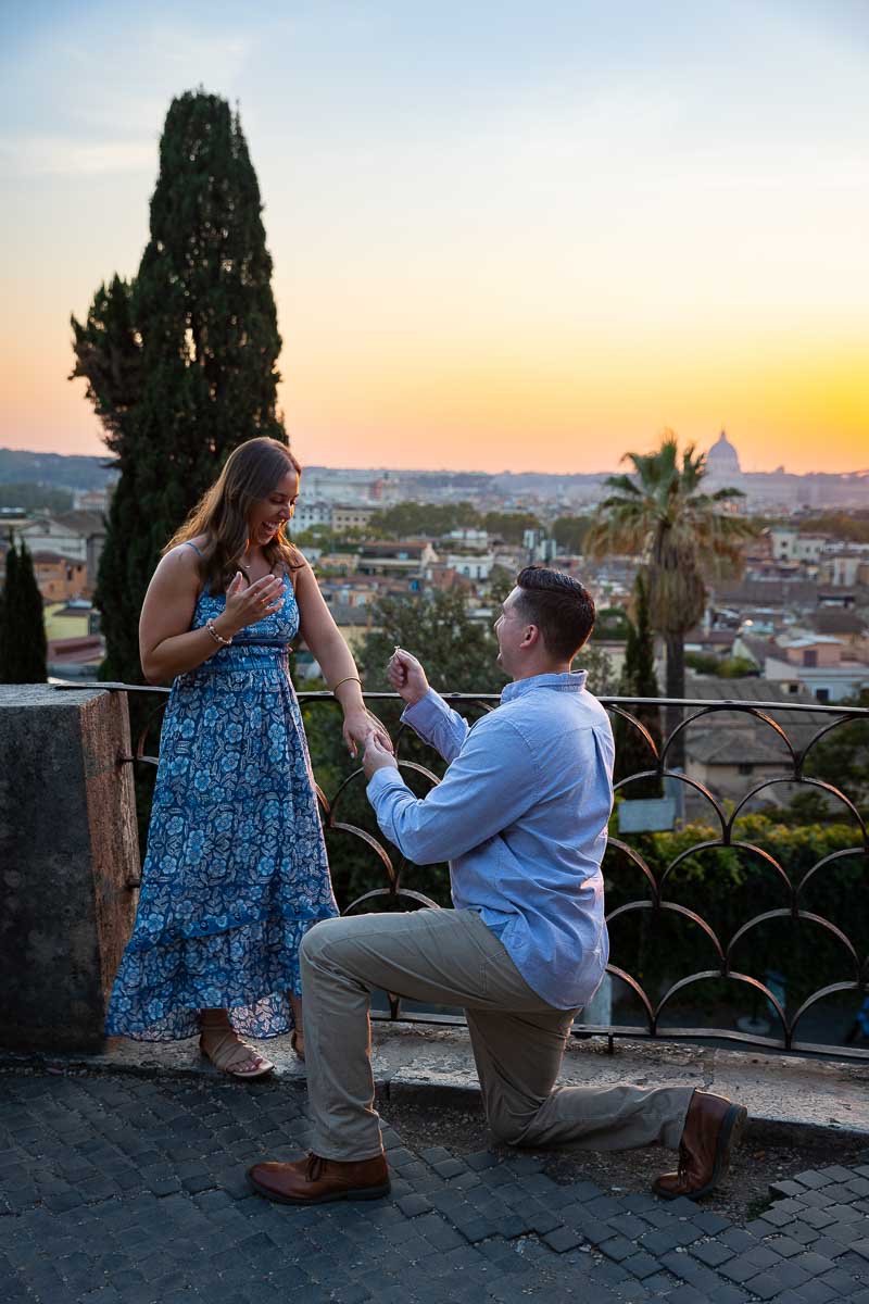Proposing marriage with an engagement ring during sunset Pincio Terrace