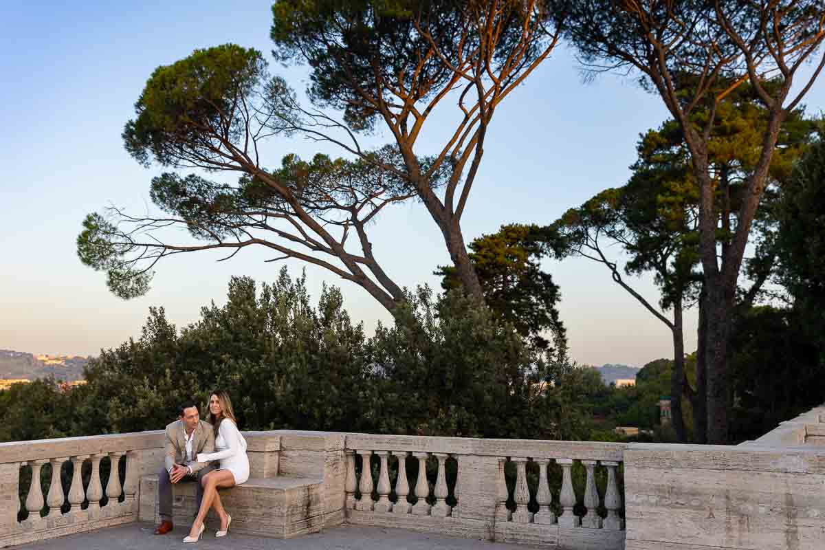 Posed underneath large Mediterranean pine trees