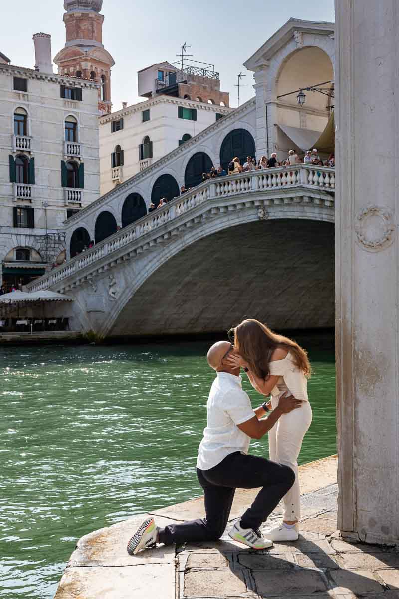 She said yes to a splendid proposition taking place by symbolic bridge and photographed by a hidden photographer