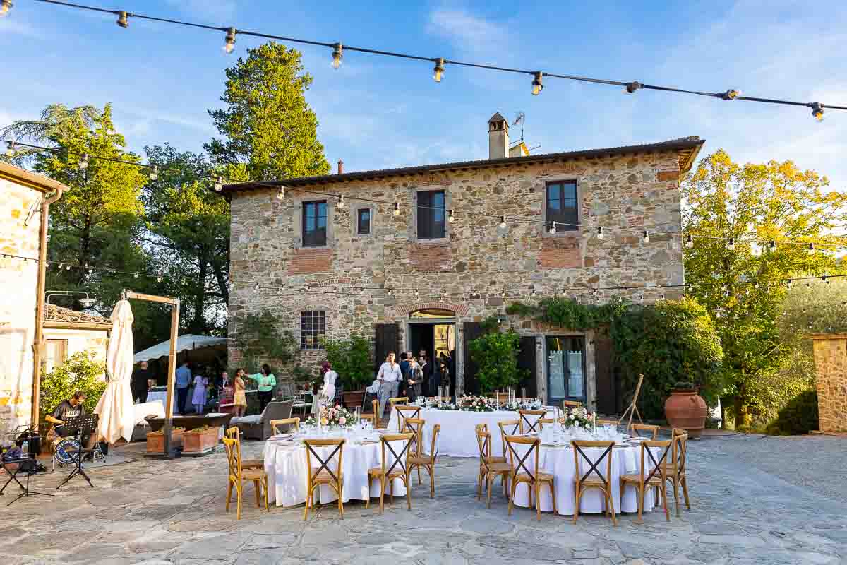 Picture of the villa photographed outside from the courtyard decorated with table set up for dinner and flowers and candles