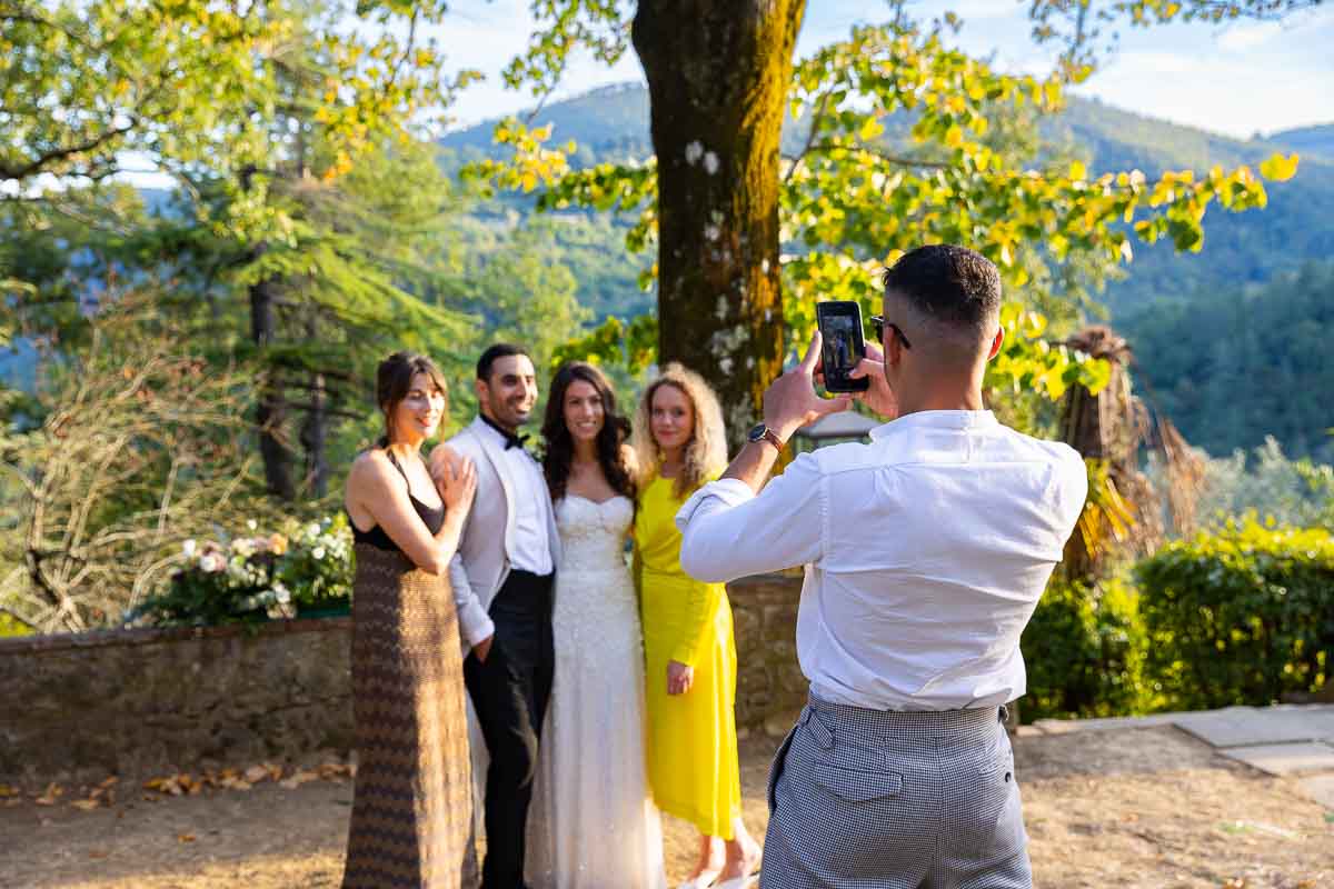 Guests taking pictures of each other on their mobile phones acting as photographers 