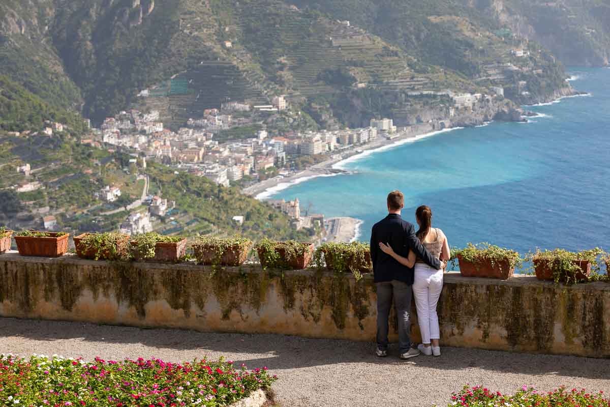 Couple portrait as they are admiring the one of a kind view of the Mediterranean sea and the beaches
