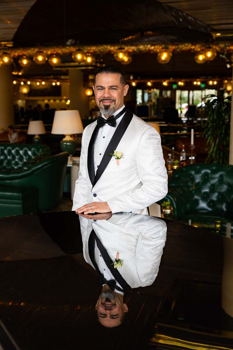 The groom taking a portrait picture during a wedding photoshoot to celebrate anniversary